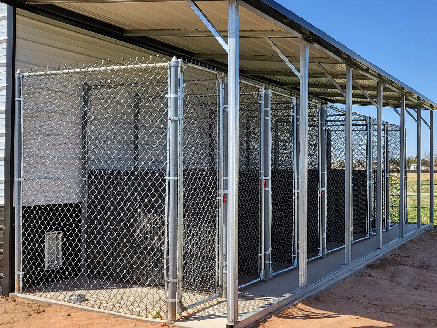 Each kennel has a covering over it so that the dogs can lay out on the concrete and enjoy the environment.